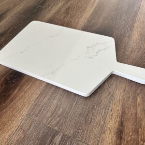 Marble cutting board on wooden floor.