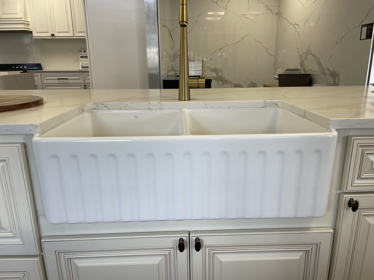 White farmhouse sink in a modern kitchen setting.