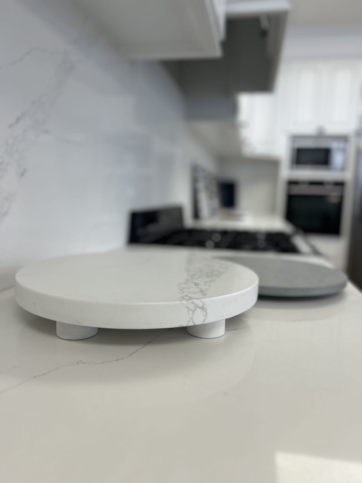 Marble kitchen countertop with round cutting boards in modern kitchen.