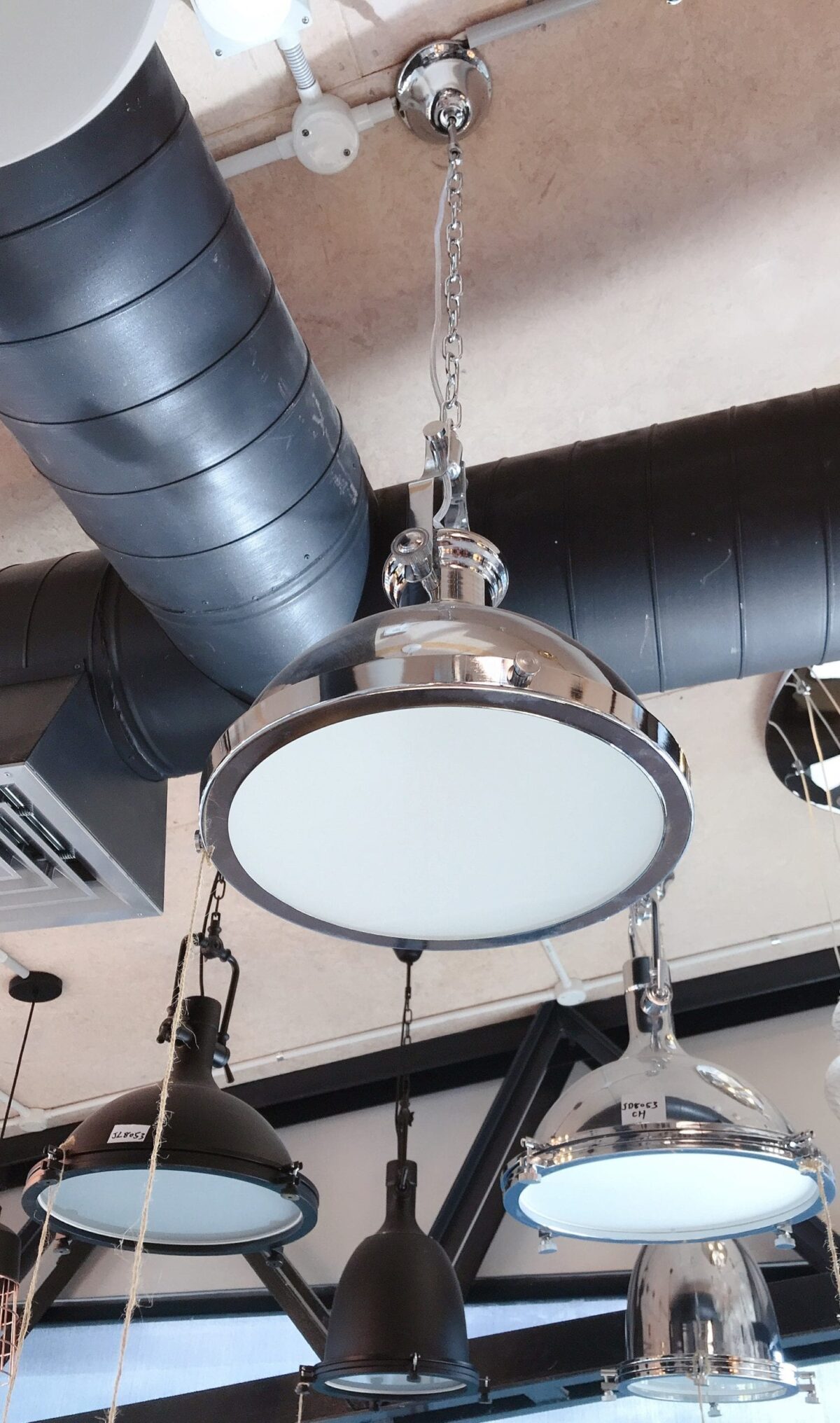 Industrial-style ceiling lights in a modern kitchen setting.