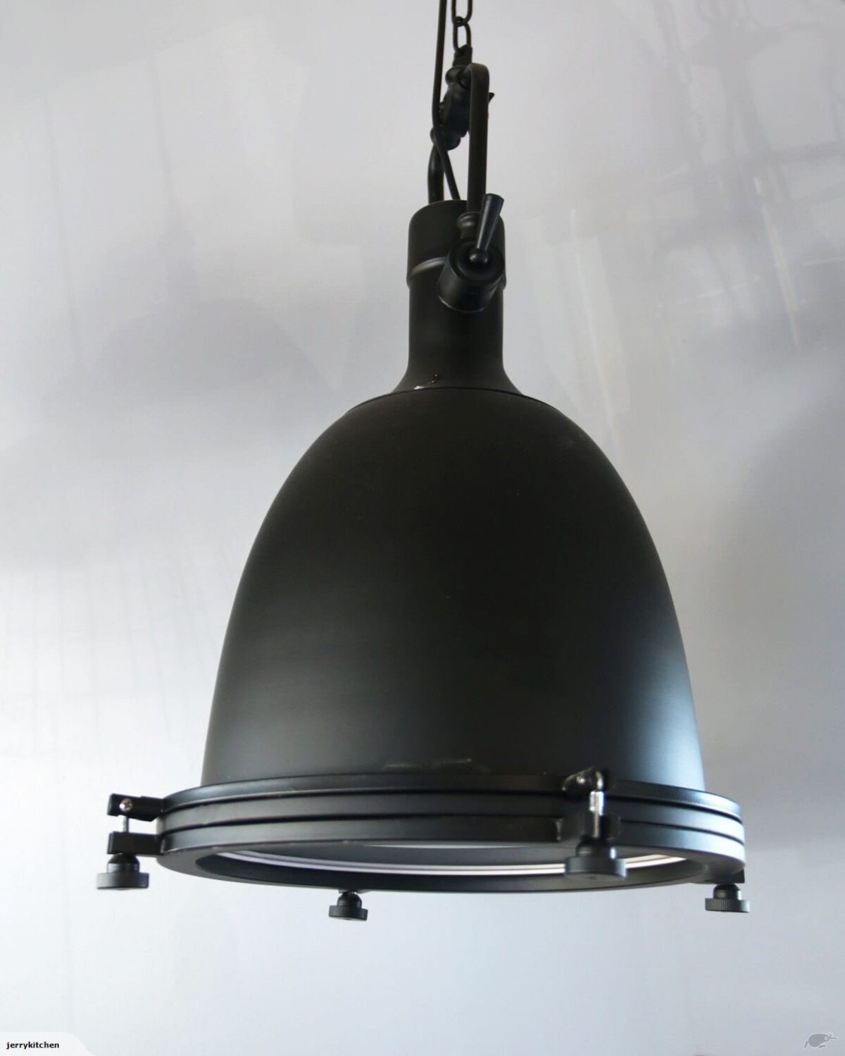 Hanging black industrial-style pendant light fixture.
