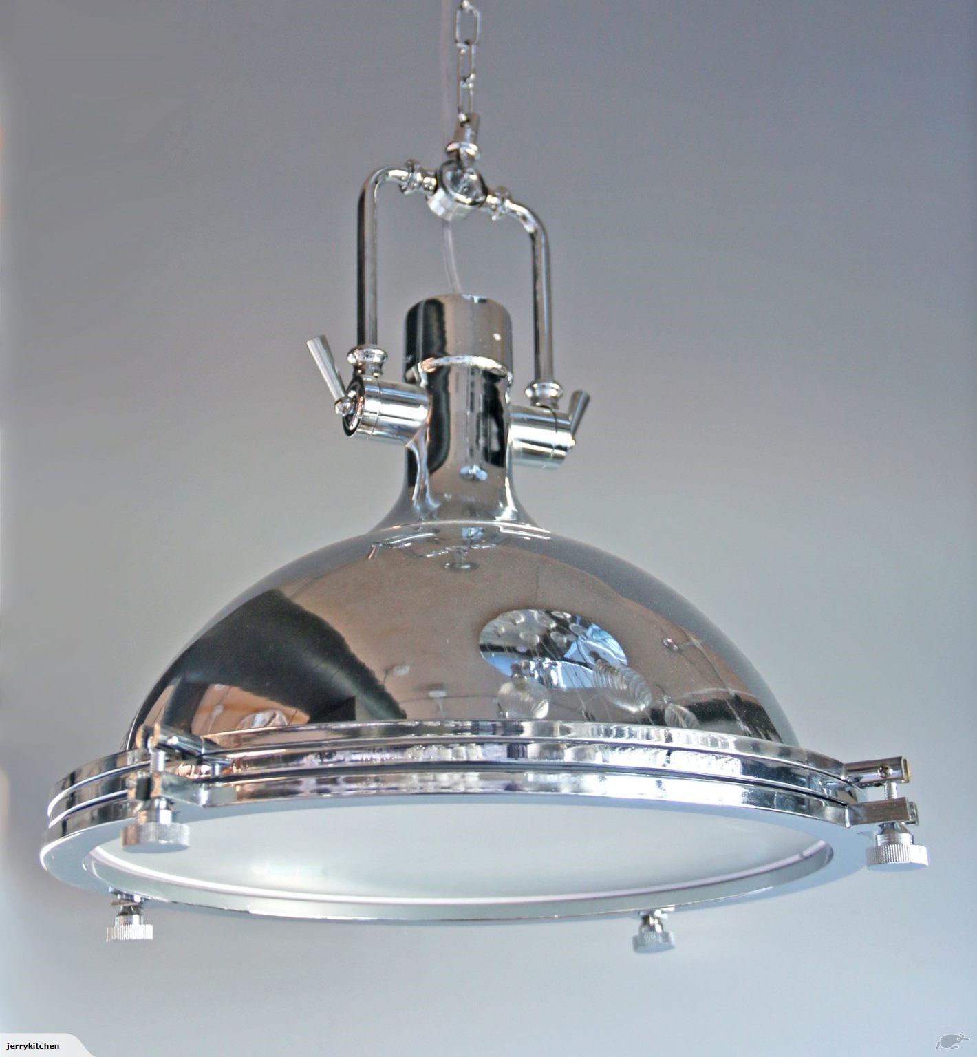 Industrial-style chrome pendant light fixture hanging from ceiling.