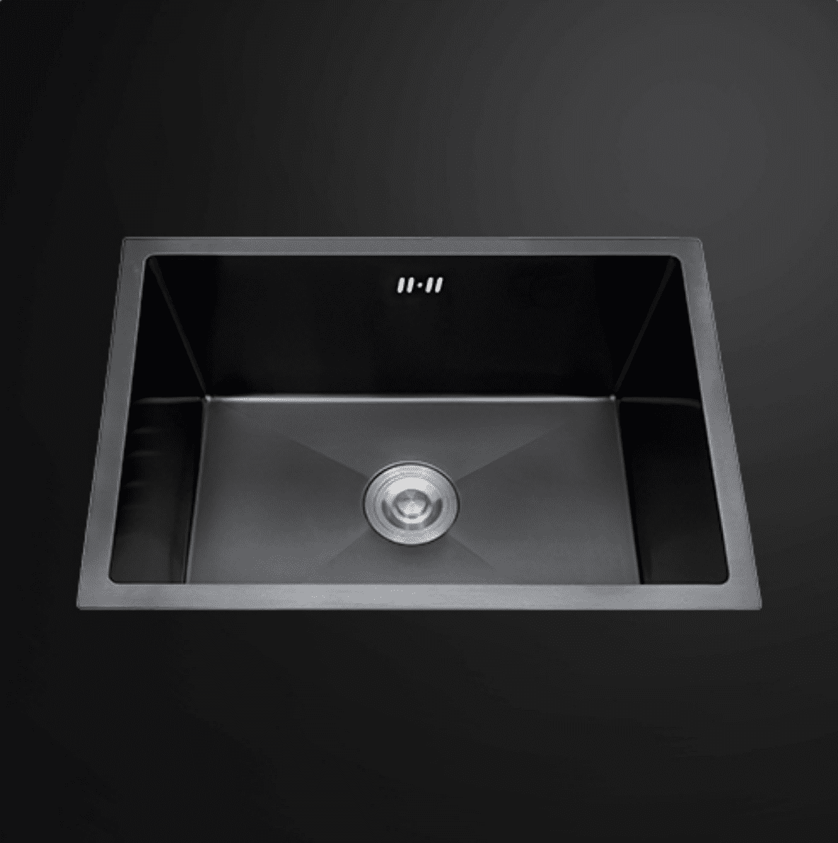 Stainless steel kitchen sink with modern design on black background.