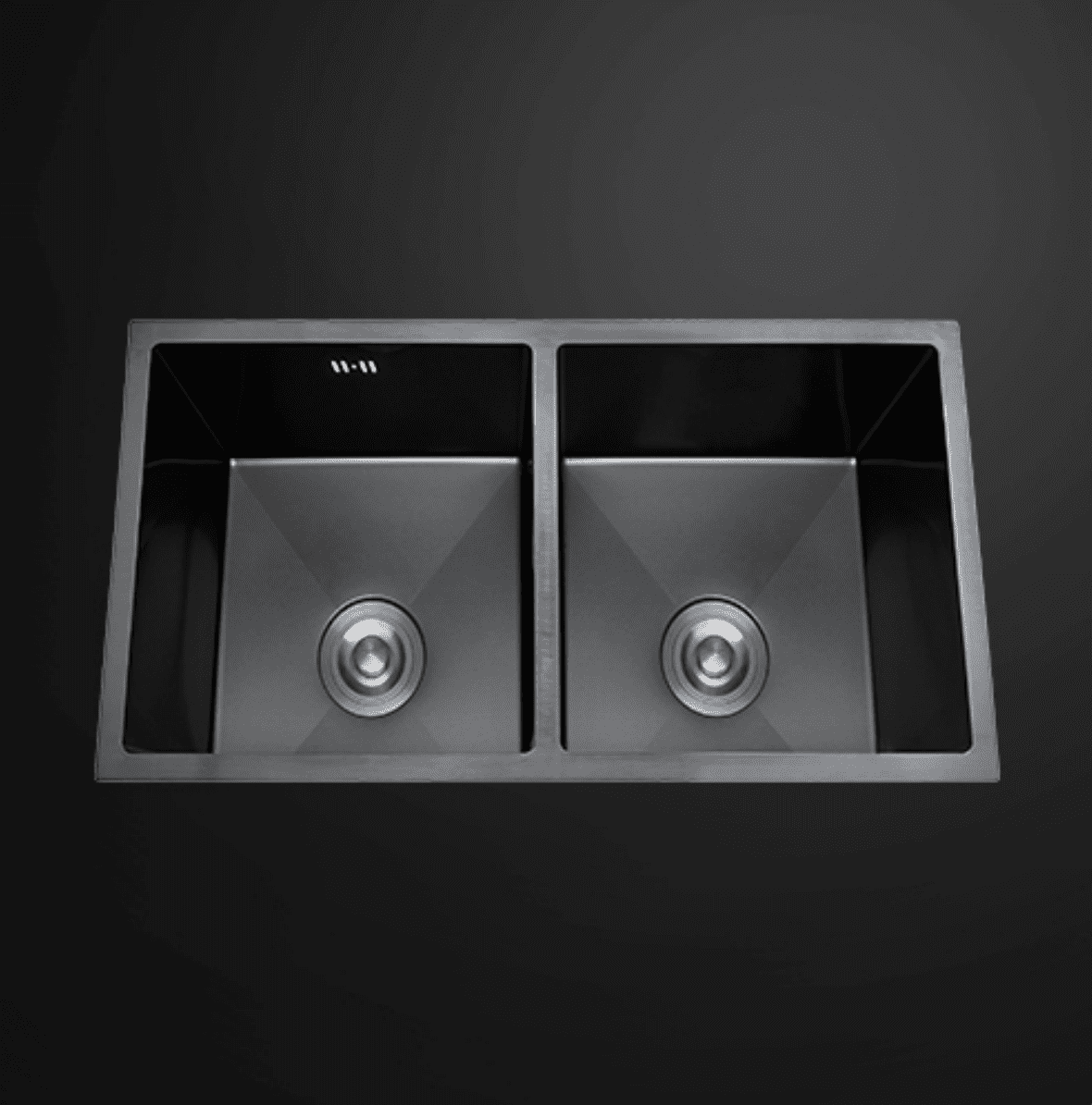Double bowl black kitchen sink on dark background.