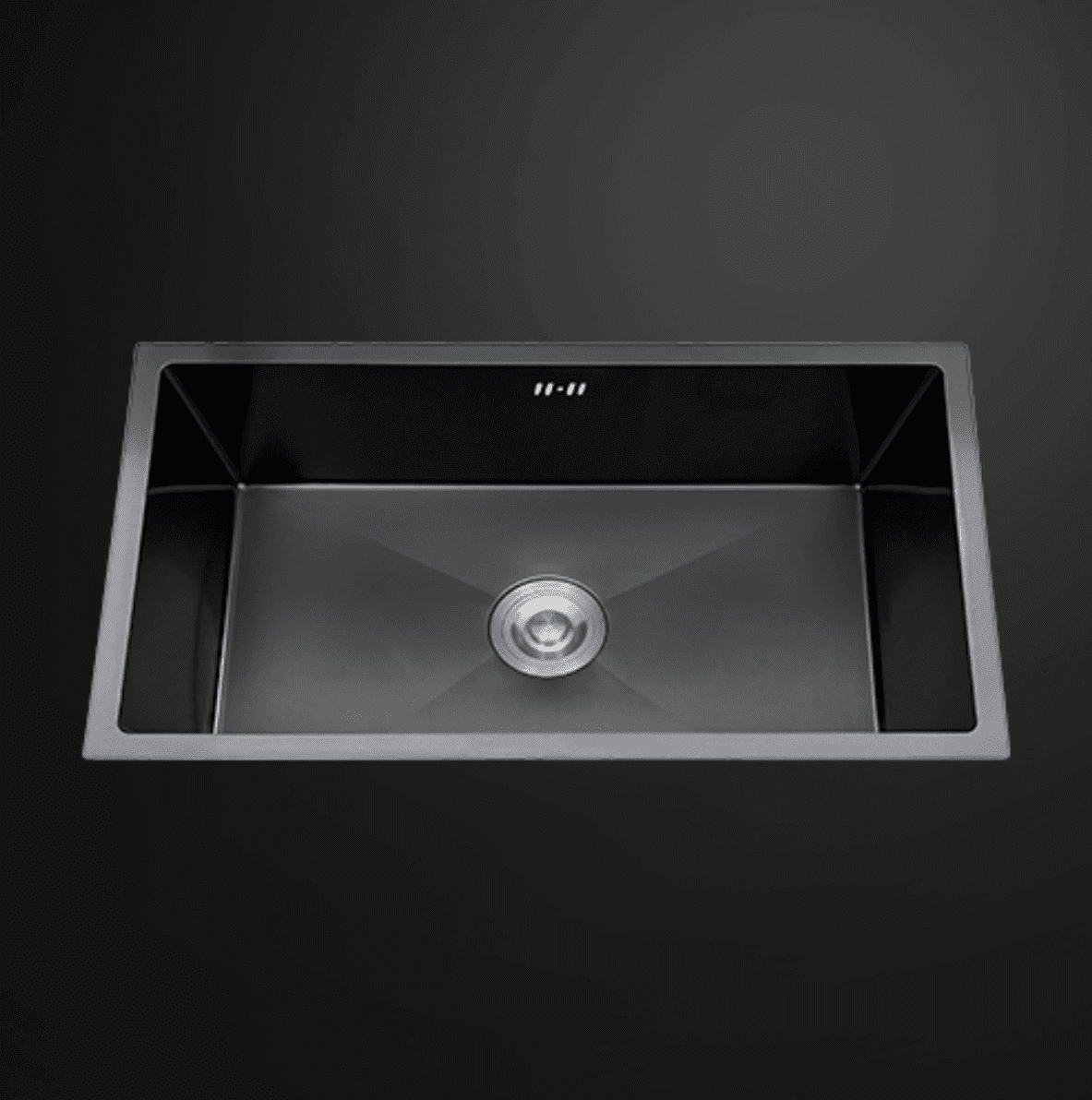 Stainless steel kitchen sink with modern design on dark background.