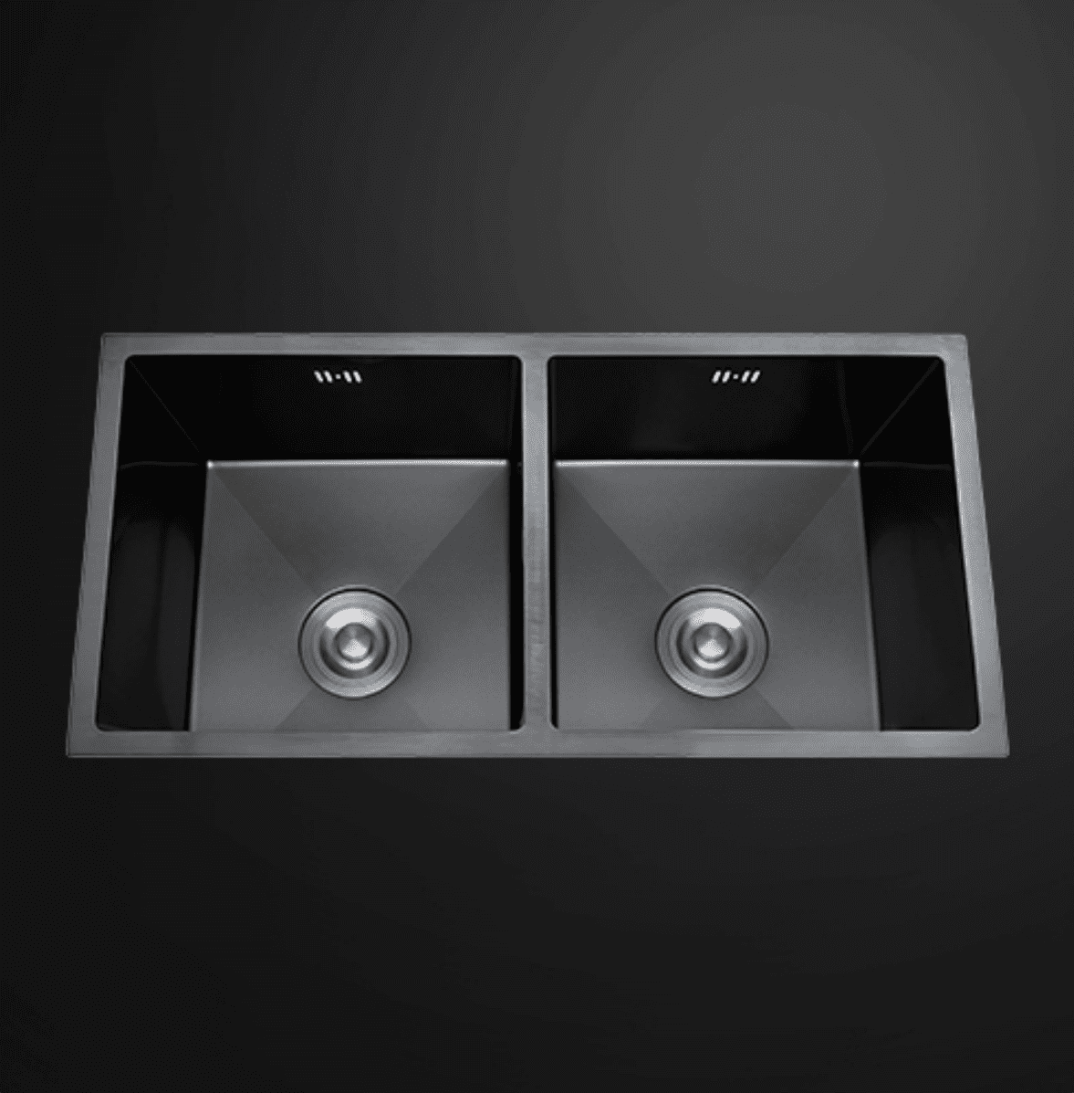 Double bowl black kitchen sink on dark background.
