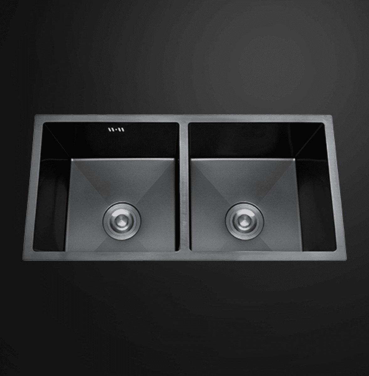 Double bowl black kitchen sink on dark background.