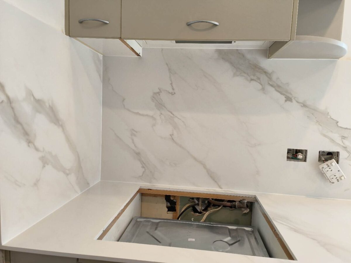Marble countertop installation in progress in a modern kitchen.