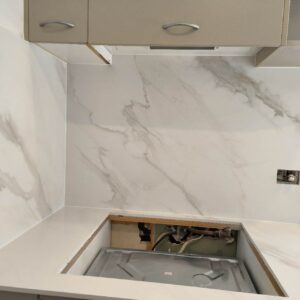Marble countertop installation in progress in a modern kitchen.