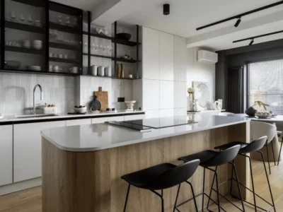 Modern kitchen with wood island, black open shelving, and minimalist white cabinets