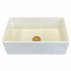 White medium butler sink with gold drain.