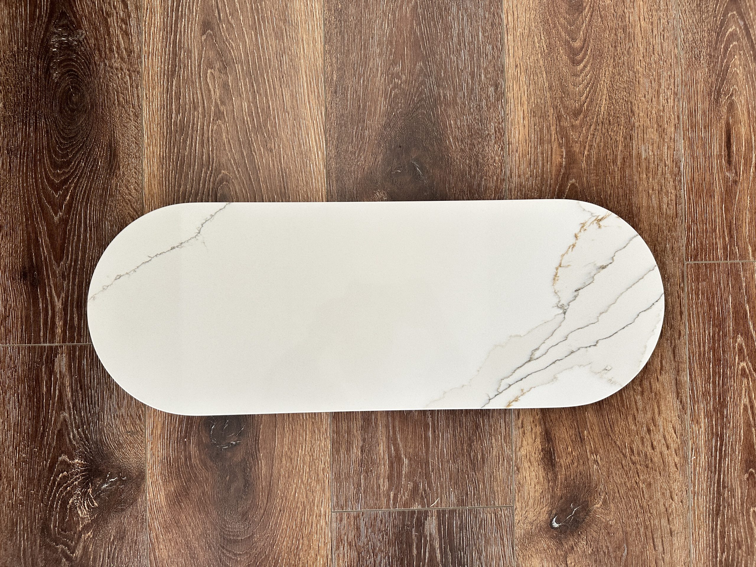 Marble serving platter on wooden floor.