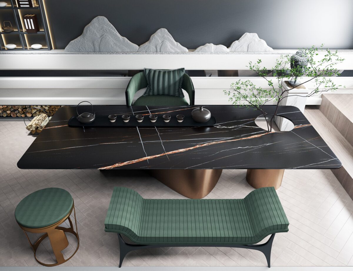 Modern black stone tea table with green seating and decorative elements.