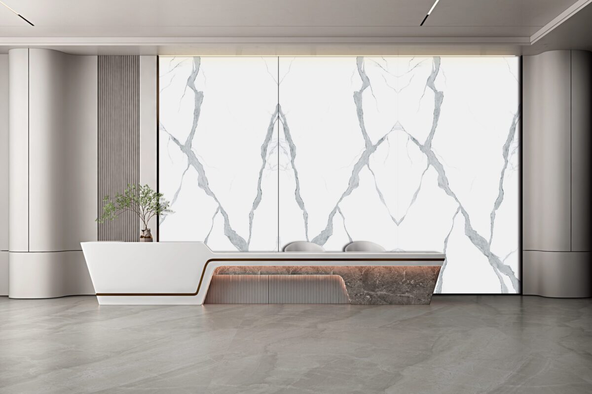 Modern interior with marble-patterned wall and sleek reception desk.