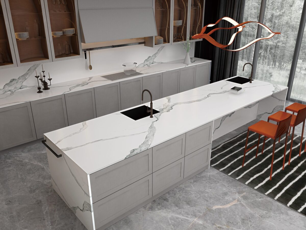 Modern kitchen with marble countertops and orange chairs.