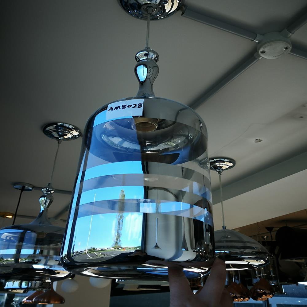Modern glass pendant light fixture with reflective chrome finish.