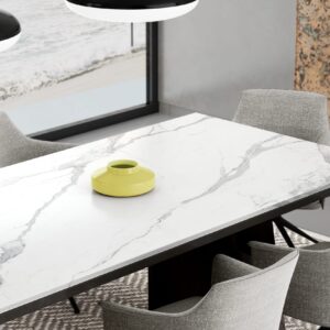 Modern kitchen table with marble surface and yellow vase.