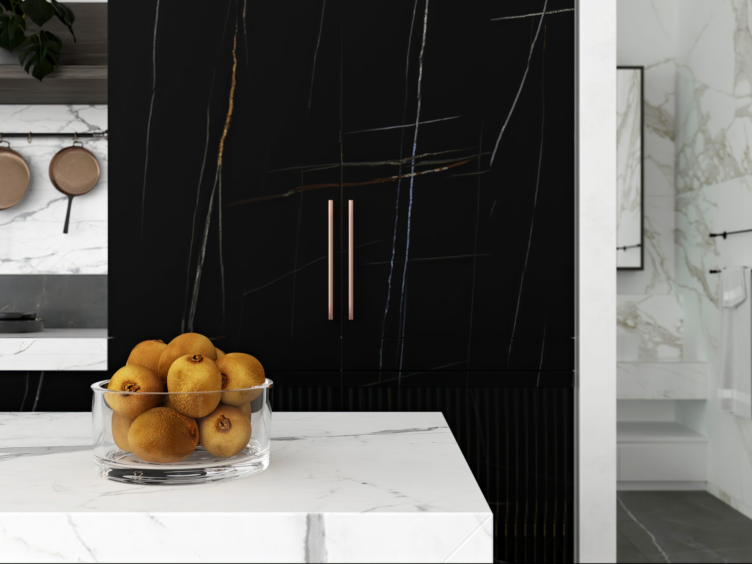 Bowl of oranges on marble counter in modern kitchen.