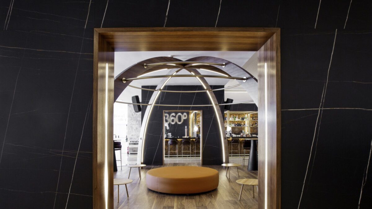 Modern restaurant interior with wooden accents and circular seating.