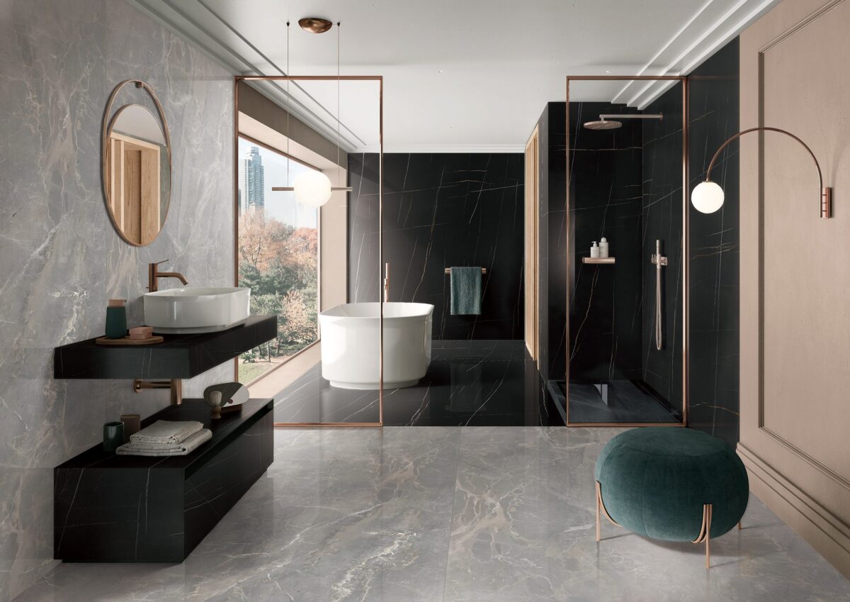 Modern bathroom with marble tiles, freestanding tub, and large window view.