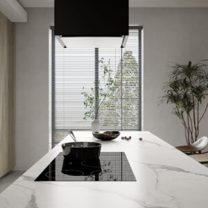 Modern kitchen island with marble countertop and induction cooktop.