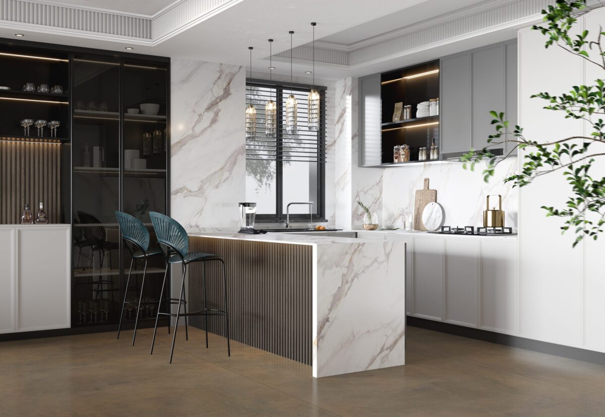 Modern kitchen with marble countertops, bar stools, and elegant lighting.